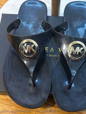 Michael Kors Black Flip Flop Sandals with Gold MK Emblems